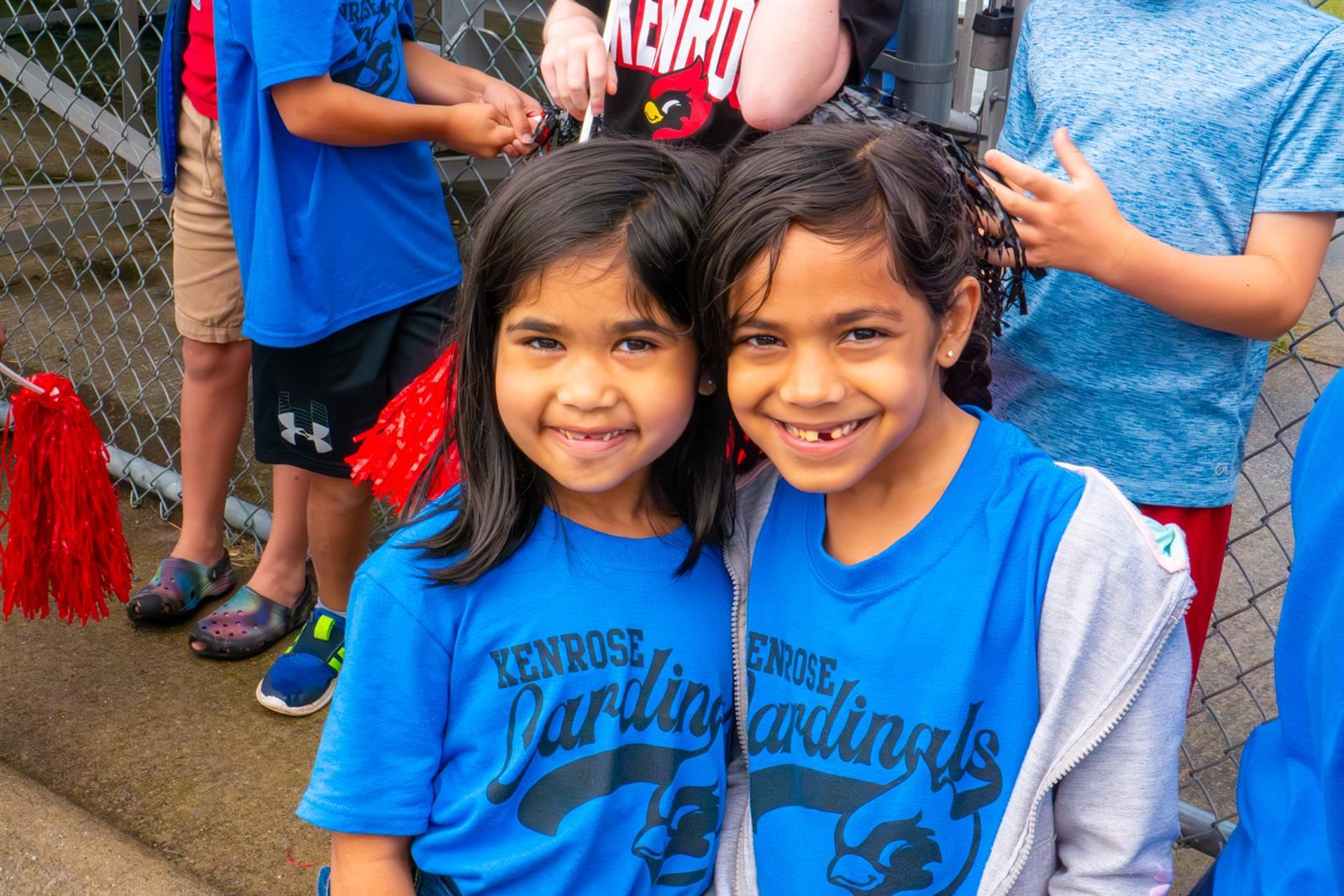 two girls in blue shirts